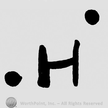 Letter H and two dots.
