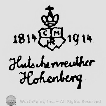A crown with cross on top of a shield;1814 , 1914 written on sides;Hutschenreuther Hohenberg written below.
