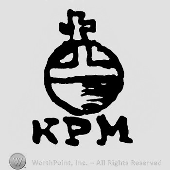 A circle with a crown on top;letters KPM below.