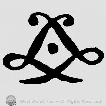 Shape similar to a diamond with a dot inside.