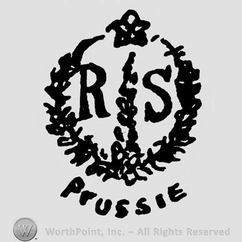 A circle made from branches with a star on top;letters R S inside;Prussie written outside.