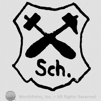 Two crossed hammers and letters Sch inside an irregular shape.