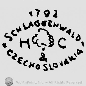 A tree and  letters H C in the middle;number 1792 on top;words Schlaggenwald and Czechoslovakia written in an oval shape.