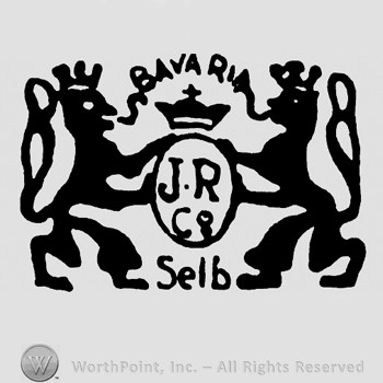 An oval with JR Co inside and a crown on top;two lions and word Bavaria on top.