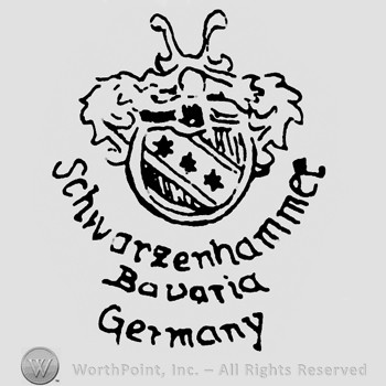 Shape similar to a shield with three stars inside;Schwarzenhammer Bavaria Germany written below.