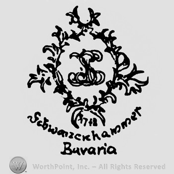 An oval made from branches with monogram of letters XS inside;Schwarzenhammer Bavaria written below.