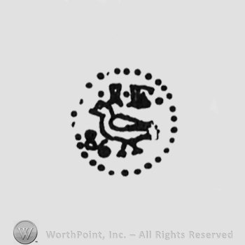 bird, initials on top I E, punctuated circle, digits 86 on the bottom on the left