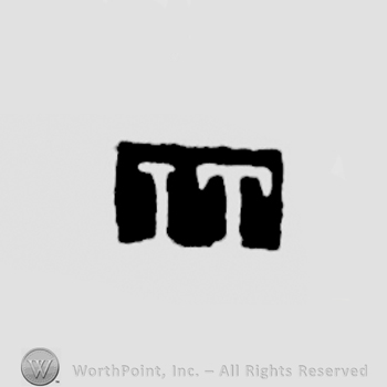 The letters IT written in uppercase