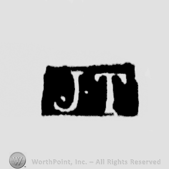 The letters JT written in uppercase