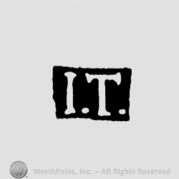 The letters I.T. written in uppercase