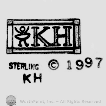 A rectangular with a double frame with a doll and letters K and H written inside, Sterling KH written with uppercase letters followed by the Copyright symbol and number 1997, all below the rectangle. 