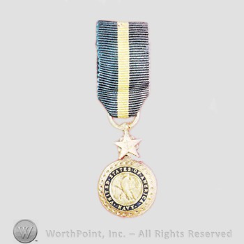 Military decoration : Navy Distinguished Service Medal.