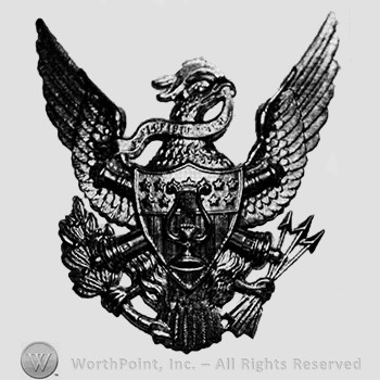 Insignia consisted of crossed cannons with a shield, over an eagle; stars and lyre on the shield.