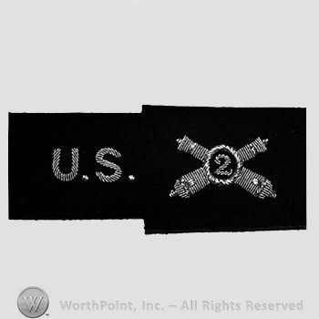 Insignia consisted of letters US and crossed cannons with number 2 in the middle.