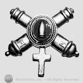 Insignia consisted of crossed cannons with a plate at the intersection; bullet on the plate and a cross below.