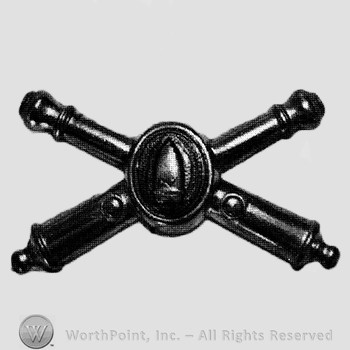 Insignia consisted of crossed cannons and shield with bullet at the intersection.