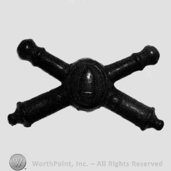 Insignia consisted of crossed cannons and shield with bullet at the intersection.