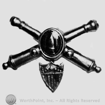 Insignia consisted of crossed cannons and shield with bullet at the intersection; shield below.