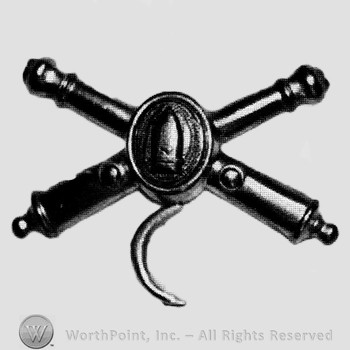 Insignia consisted of crossed cannons and a bullet at the intersection; crescent below.