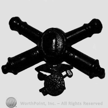 Insignia consisted of crossed cannons and a bullet at the intersection; compass below.