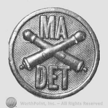 Insignia consisted of crossed cannons and letters MA above and DET below; all on a disc.