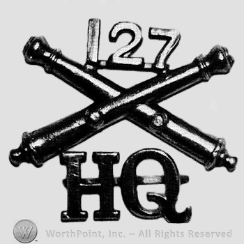 Insignia consisted of crossed cannons and number 127 above; letters HQ below.