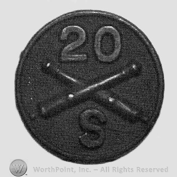 Insignia consisted of crossed cannons and number 20 above and letter S below; all on a disc.