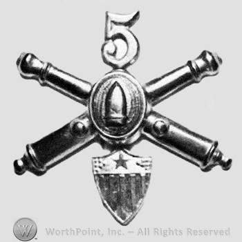 Insignia consisted of crossed cannons with a bullet at the intersection and a shield below; number 5 above.
