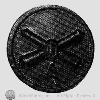 Insignia consisted of crossed cannons and a bullet at the intersection; letter A below; all on a disc.