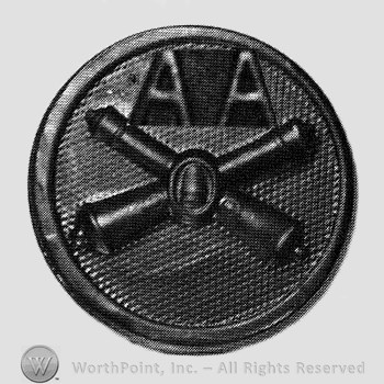 Insignia consisted of crossed cannons and a bullet at the intersection; letters AA above; all on a disc.