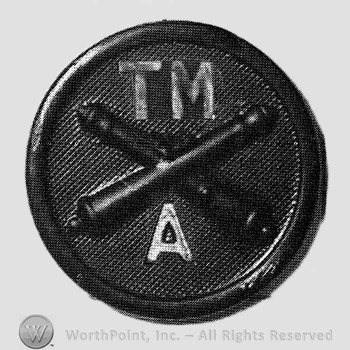 Insignia consisted of crossed cannons and letters TM above and A below; all on a disc.
