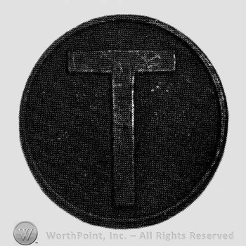Letter T on a disc.