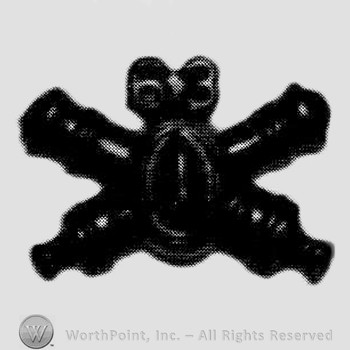 Insignia consisted of crossed cannons and number 63 above.