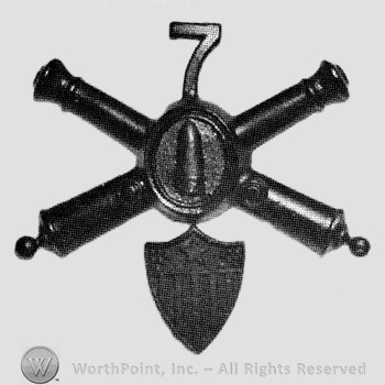 Insignia consisted of crossed cannons with bullet at the intersection and number 7 above; shield below.