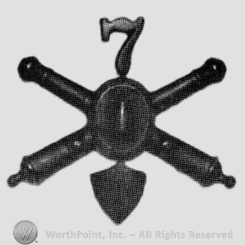 Insignia consisted of crossed cannons with bullet at the intersection and number 7 above; shield below.