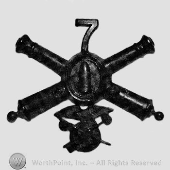 Insignia consisted of crossed cannons with bullet at the intersection and number 7 above; wheel below.
