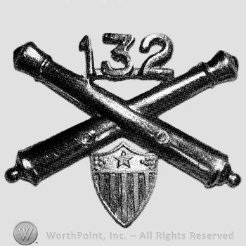 Insignia consisted of crossed cannons, number 132 above and a shield below.