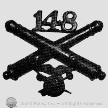 Insignia consisted of crossed cannons, number 148 above nd a wheel below.