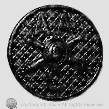 Insignia consisted of crossed cannons with a bullet at the intersection and letter C below, letters AA above; all on a plate.