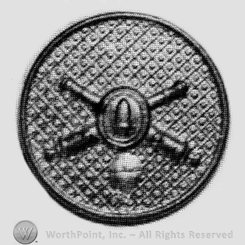 Insignia consisted of crossed cannons with a bullet at the intersection; all on a plate.