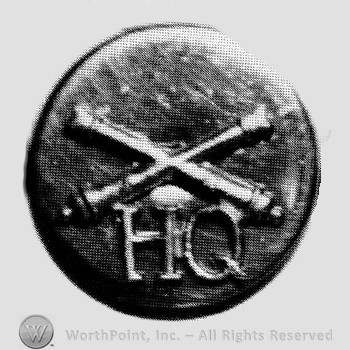 Insignia consisted of crossed cannon and letters HQ below; all on a plate.