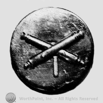 Insignia consisted of crossed cannon and number 1 below; all on a plate.