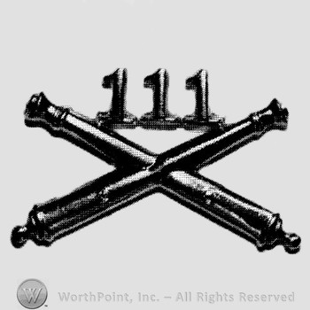 Insignia consisted of crossed cannon and number 111 above.