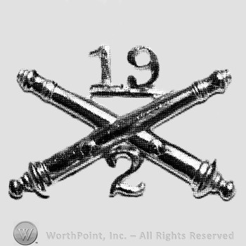 Insignia consisted of crossed cannon and number 19 above and number 2 below.