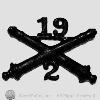 Insignia consisted of crossed cannon and number 19 above and number 2 below.