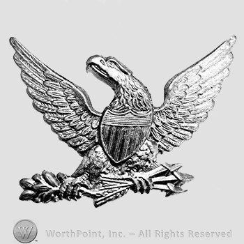 Insignia consisted of an eagle with displaced wings; shield on its breast, grasps three arrows in its left talon and an plive branch in its right talon.
