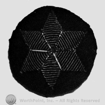 Insignia consisted of  six-pointed star embroidered on a dark blue background.