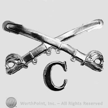 Insignia consisted of crossed sabres and letter C at the intersection.