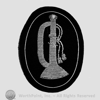 Insignia consisted of a trumpet with wires; embroidered.