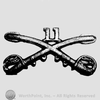 Insignia consisted of crossed sabres and number 11 at the intersection.